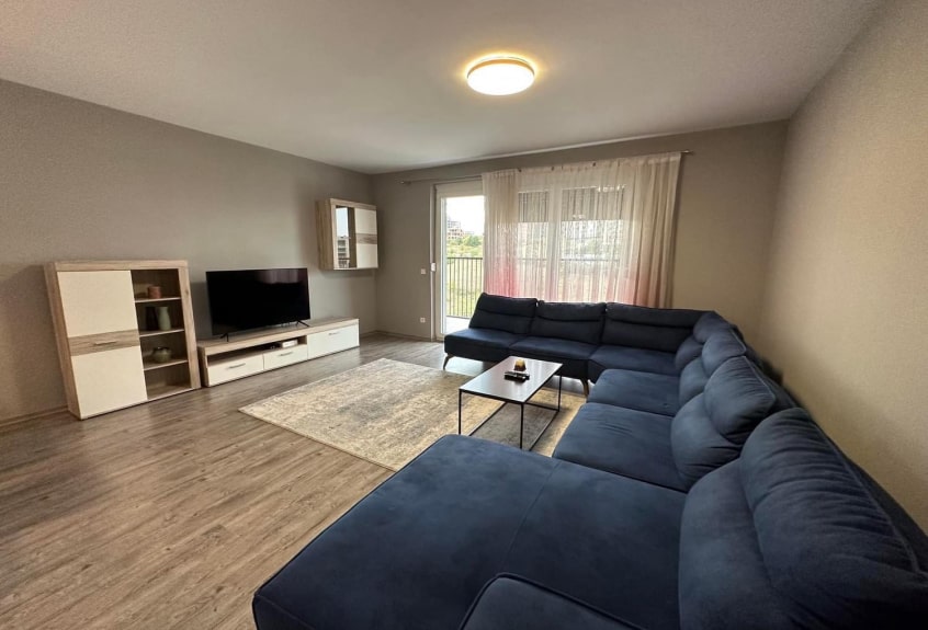 View of the living room with large windows overlooking the lake