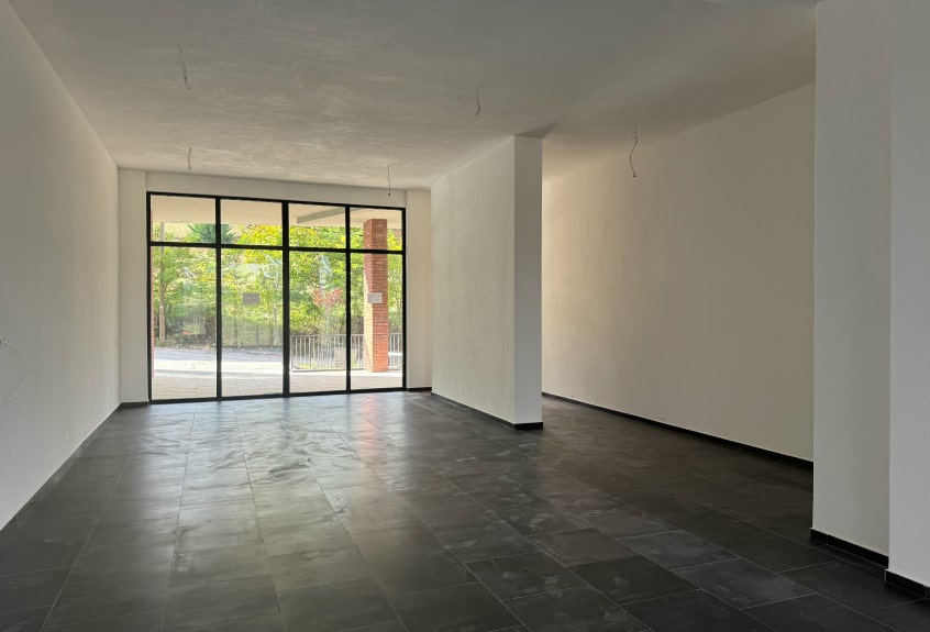 View of the living room with large windows overlooking the lake