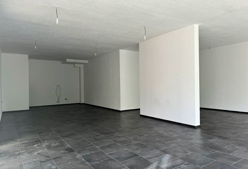 View of the living room with large windows overlooking the lake